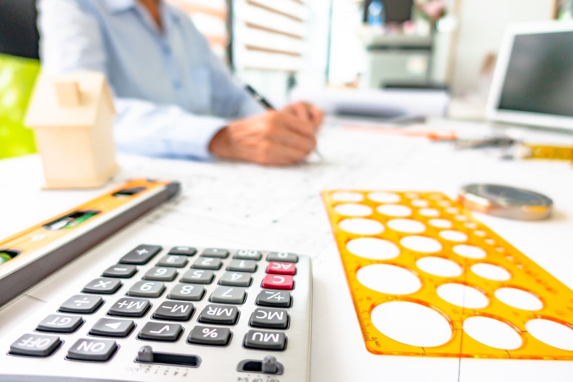 Asian engineer woman checking architecture plan project at working office room.